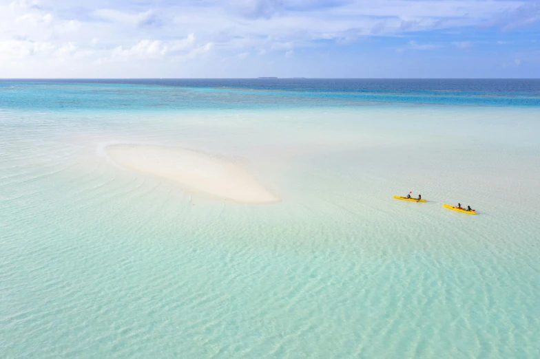 two people are out in the water in kayaks