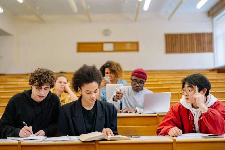 some students doing homework in a large lecture hall