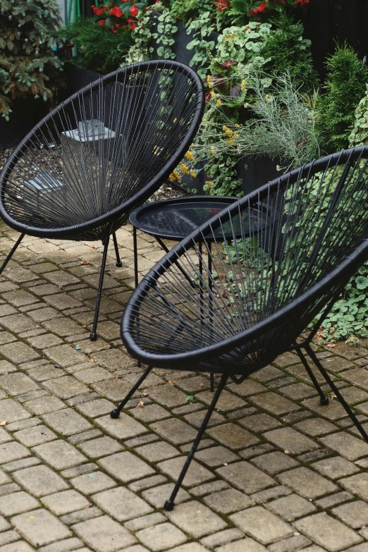 three chairs sitting in the middle of a garden