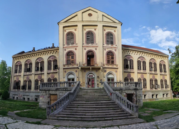 a very old building with several windows and a lot of stairs