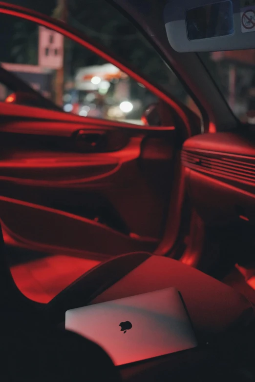 a view from the inside of a car at night with people