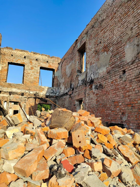 a pile of rocks and bricks sitting near a building