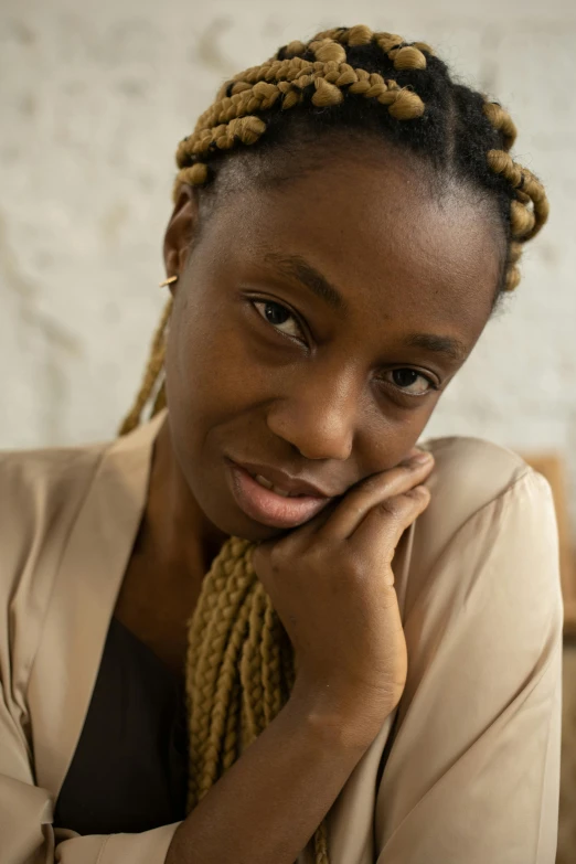 a woman smiles and leans with a smile on her face