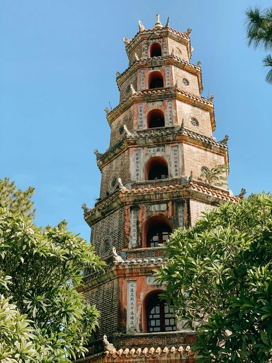 a tall tower with ornate towers, and two windows