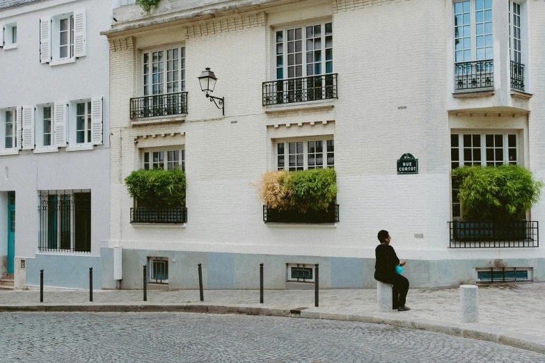 a woman standing next to an older building