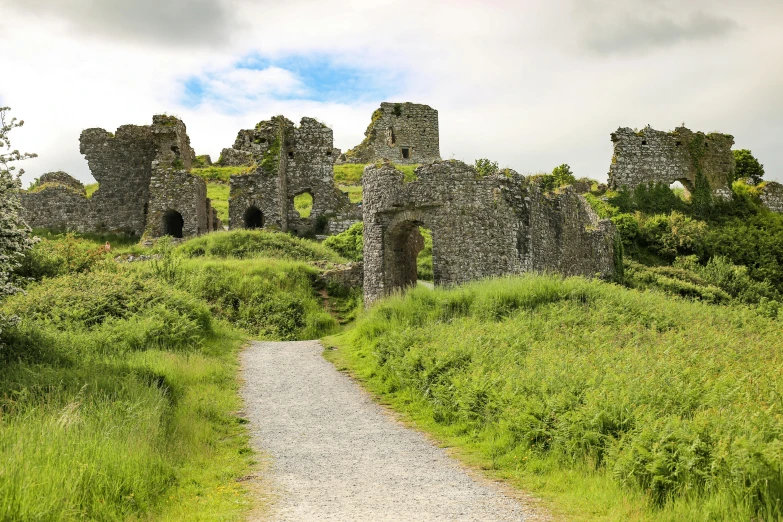 a dirt path and several ruins in an area