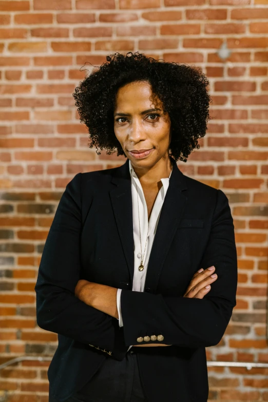 a woman with her arms crossed in front of her face