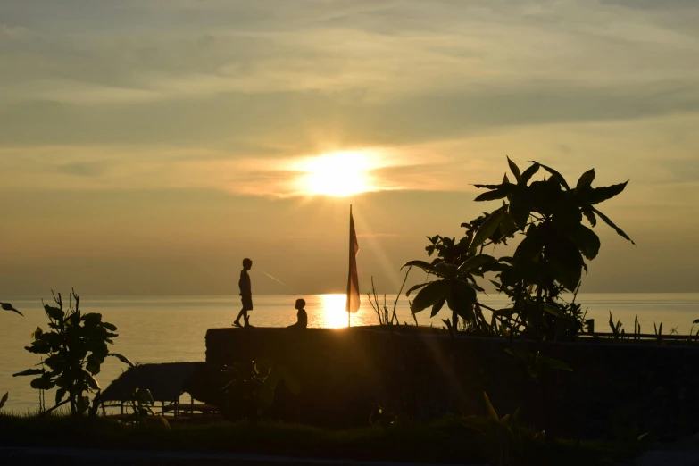 a couple of people standing on top of a pier