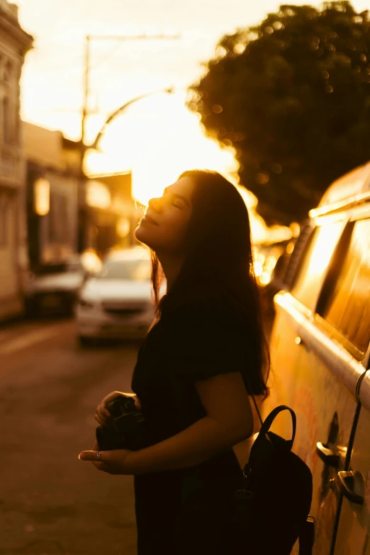 a woman standing on the side of a road