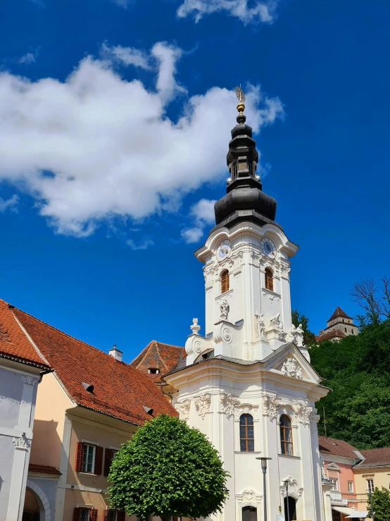 a very tall tower sitting next to a bunch of houses