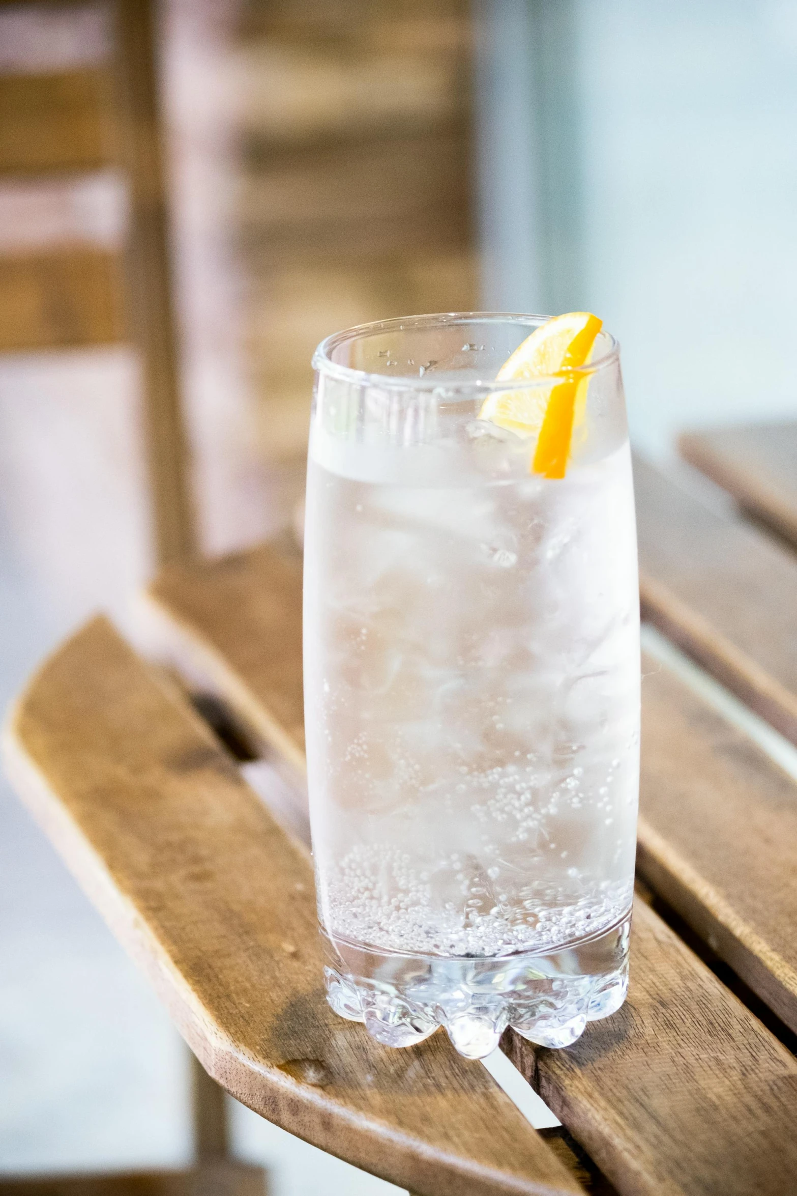 an orange peel is stuck on the side of a drink in a glass