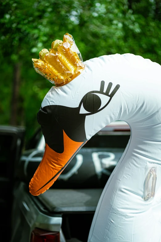 a duck shaped pinata wearing a crown