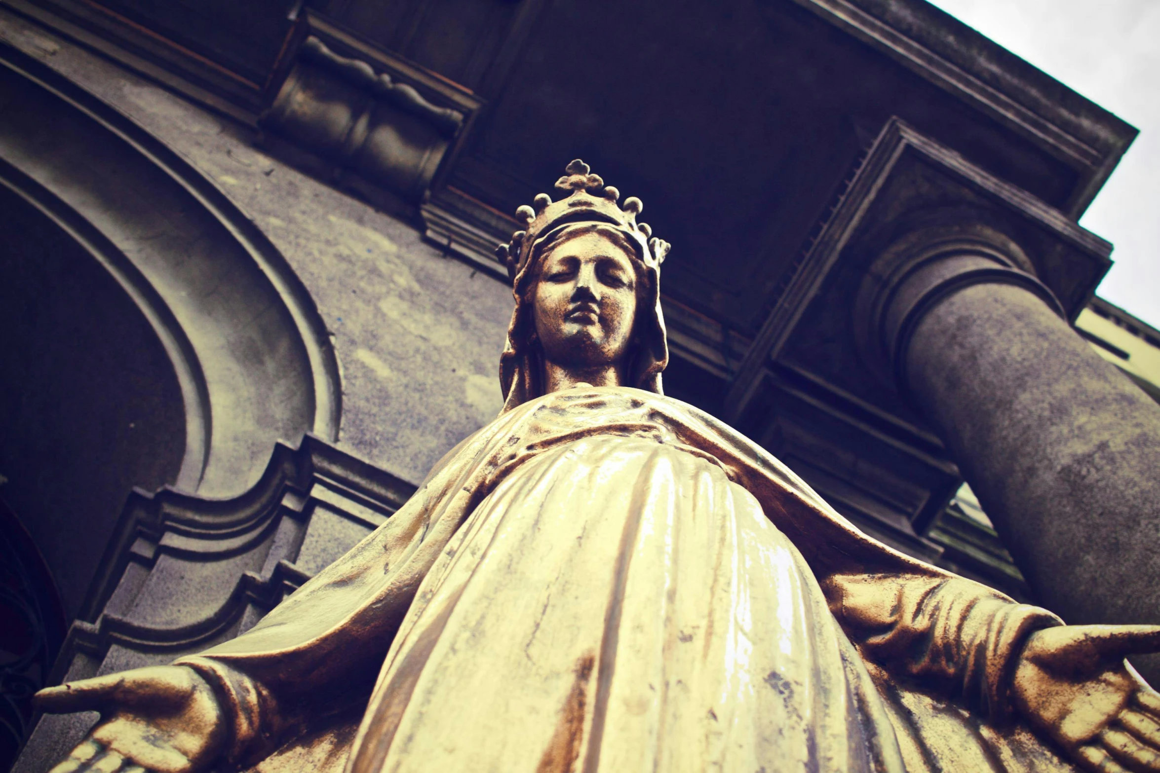 a close up of the head of the statue of jesus with arms outstretched