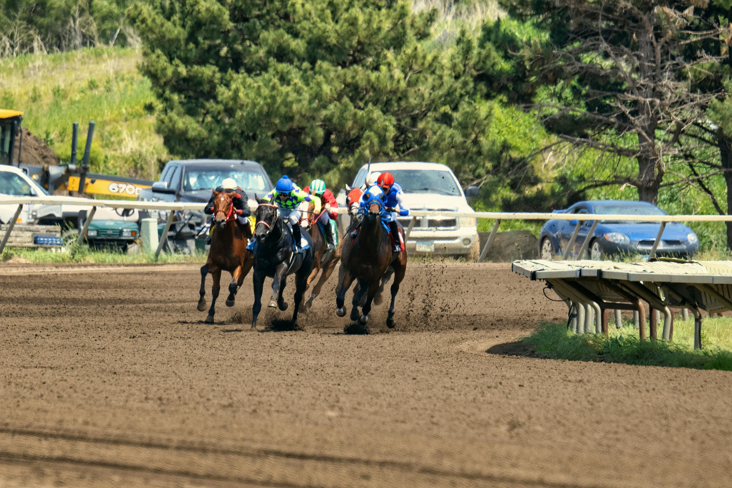 three jockeys are racing horses around the track