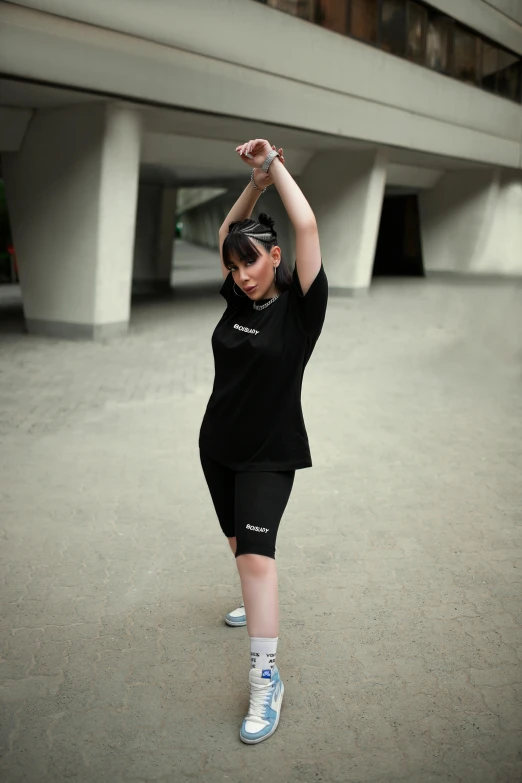 an asian woman doing a move with her hands on one side