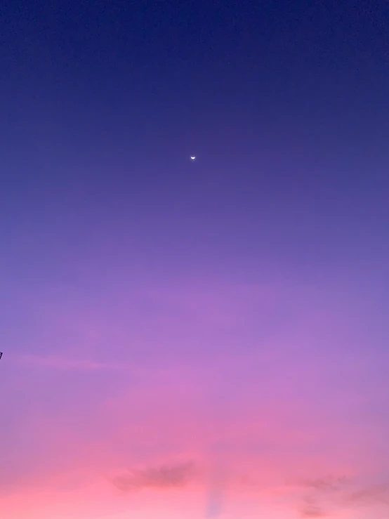 pinkish colored sky with two airplane jets flying overhead