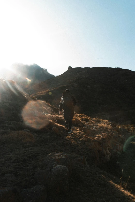 people are walking up a hill and hiking