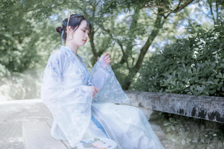 woman in traditional korean dress with trees in background