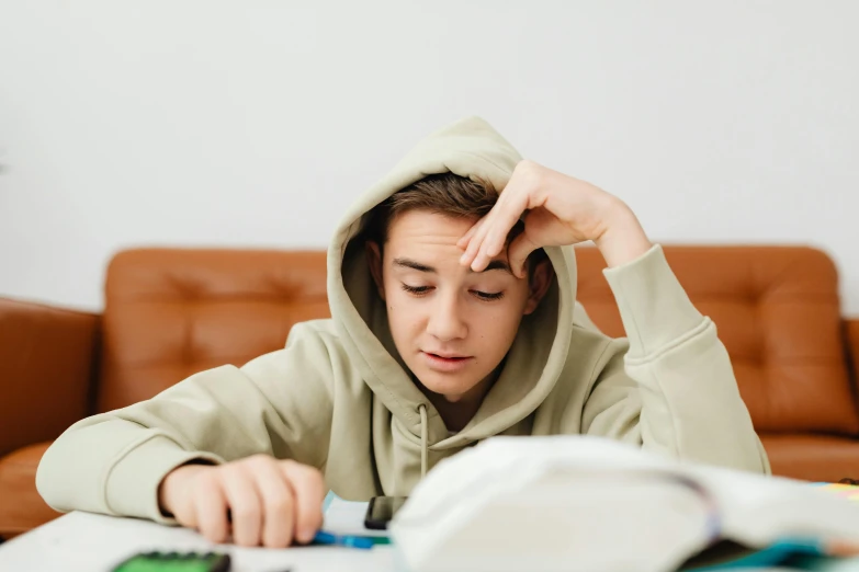 the young man is working on his computer at home