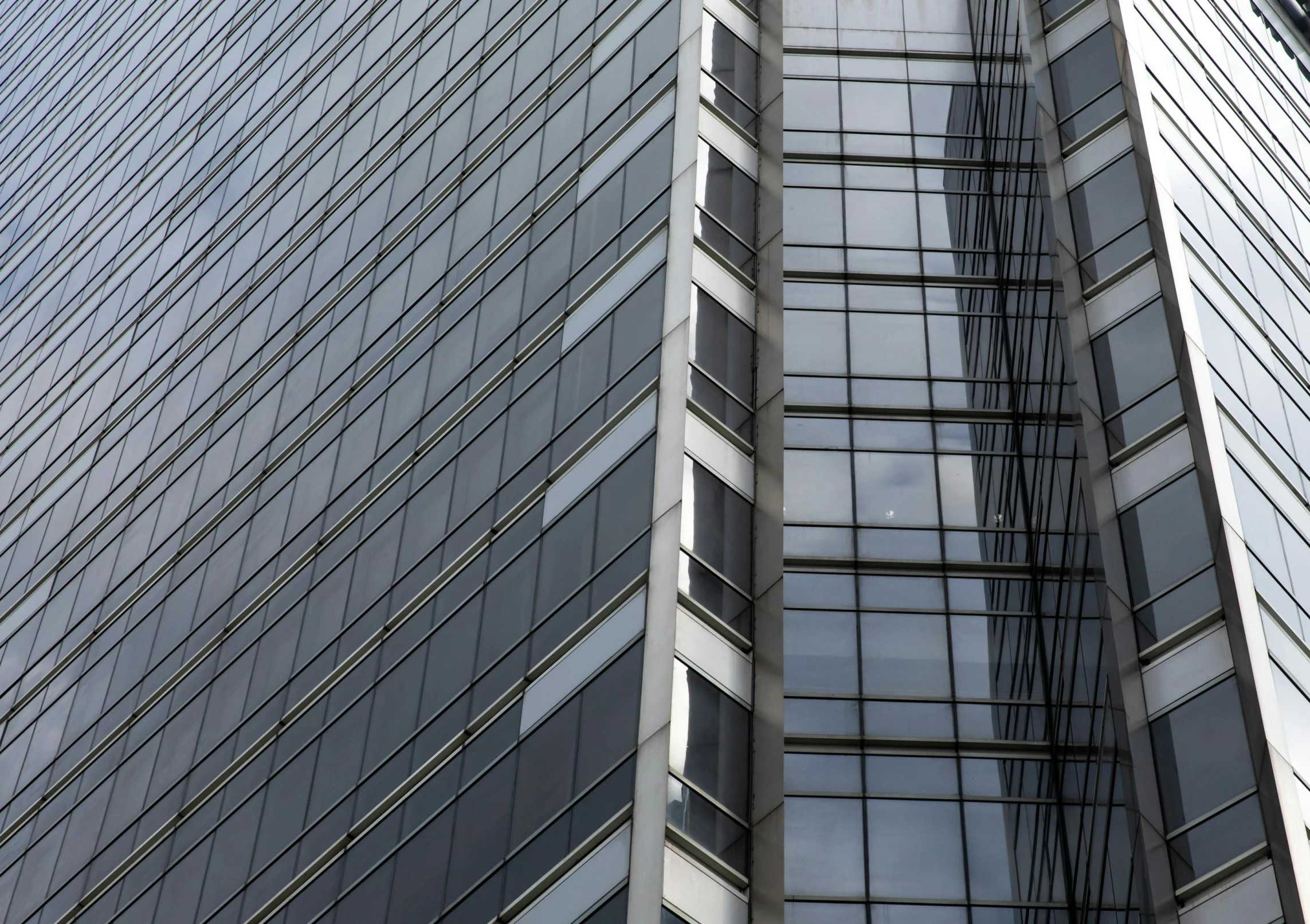 two tall buildings with many windows and a clock at the top