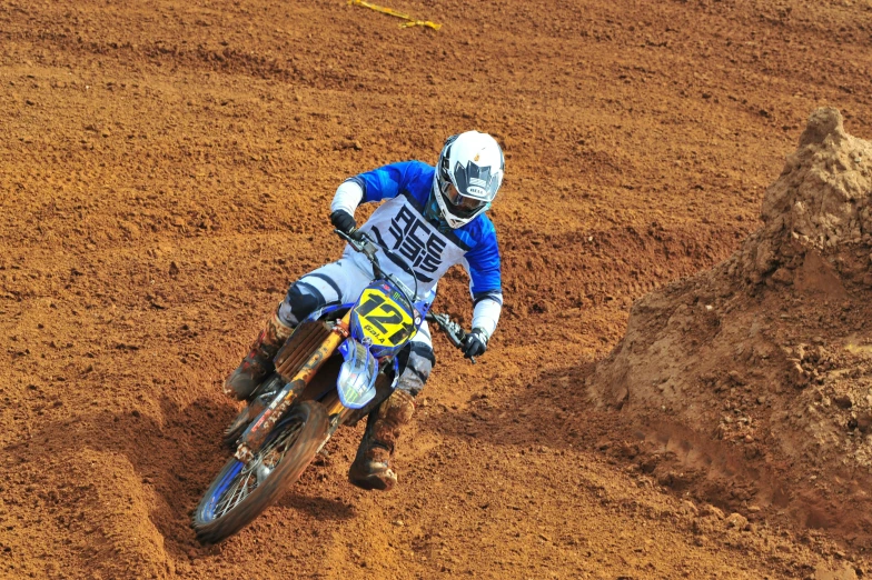 a dirt bike rider is driving down the track