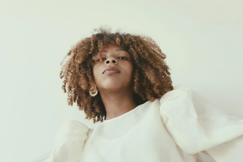 an african american woman with afro hair posing for the camera