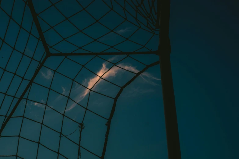 the moon appears in a clear blue sky as it shines