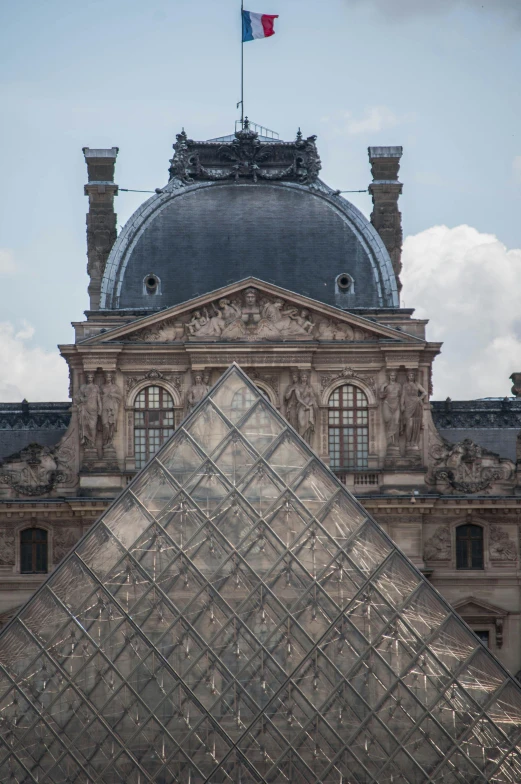 the top of the pyramid is visible in front of an old building