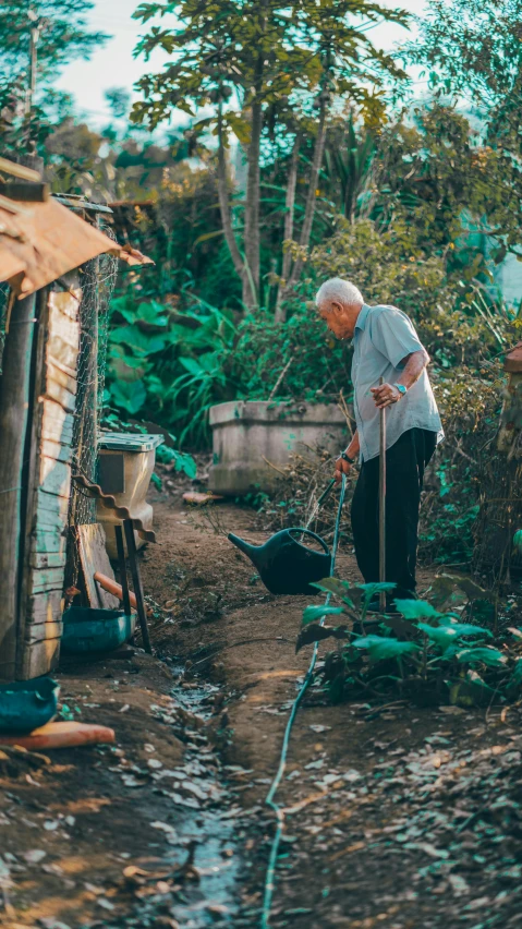 an old woman stands outside in the dirt