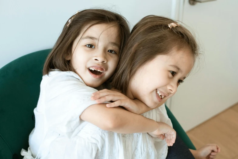 a couple of girls that are sitting down together