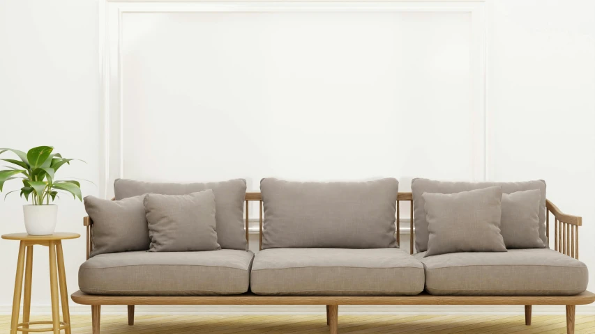 a small couch sits in front of a white wall