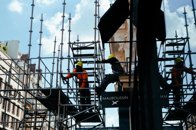 a group of people standing on top of scaffolding