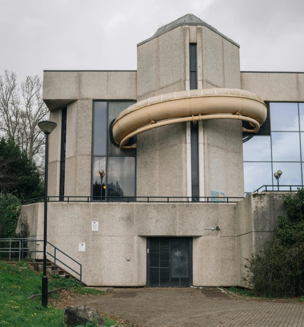 a concrete structure with a circular staircase leading up to it