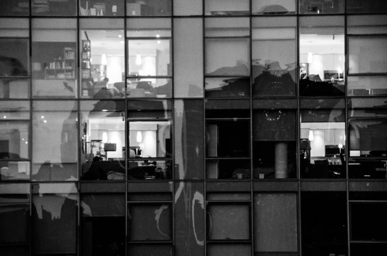 an open window in a building with some windows reflecting people