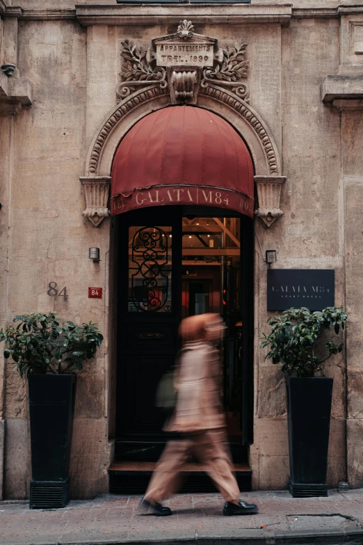 a large building with a red awning outside