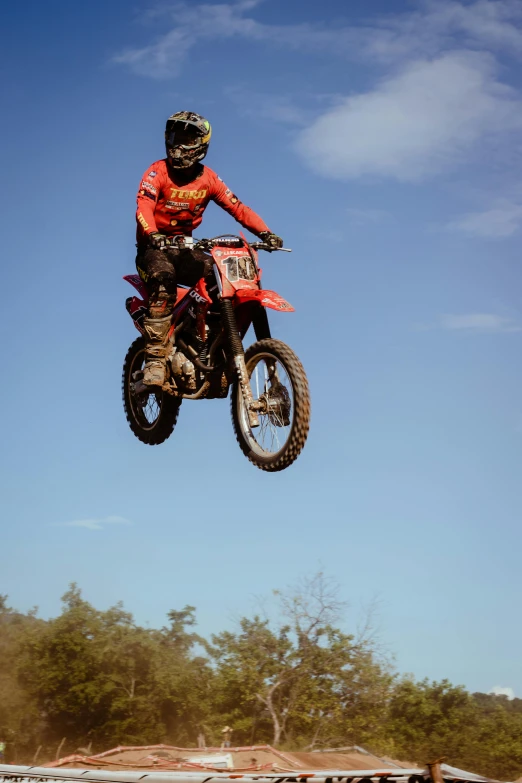 a man riding a motorcycle through the air