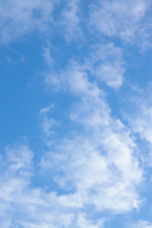 a picture of some clouds with a plane