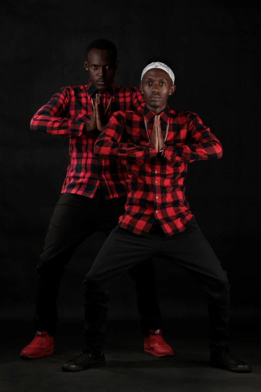 two young men pose for a portrait in plaid shirts