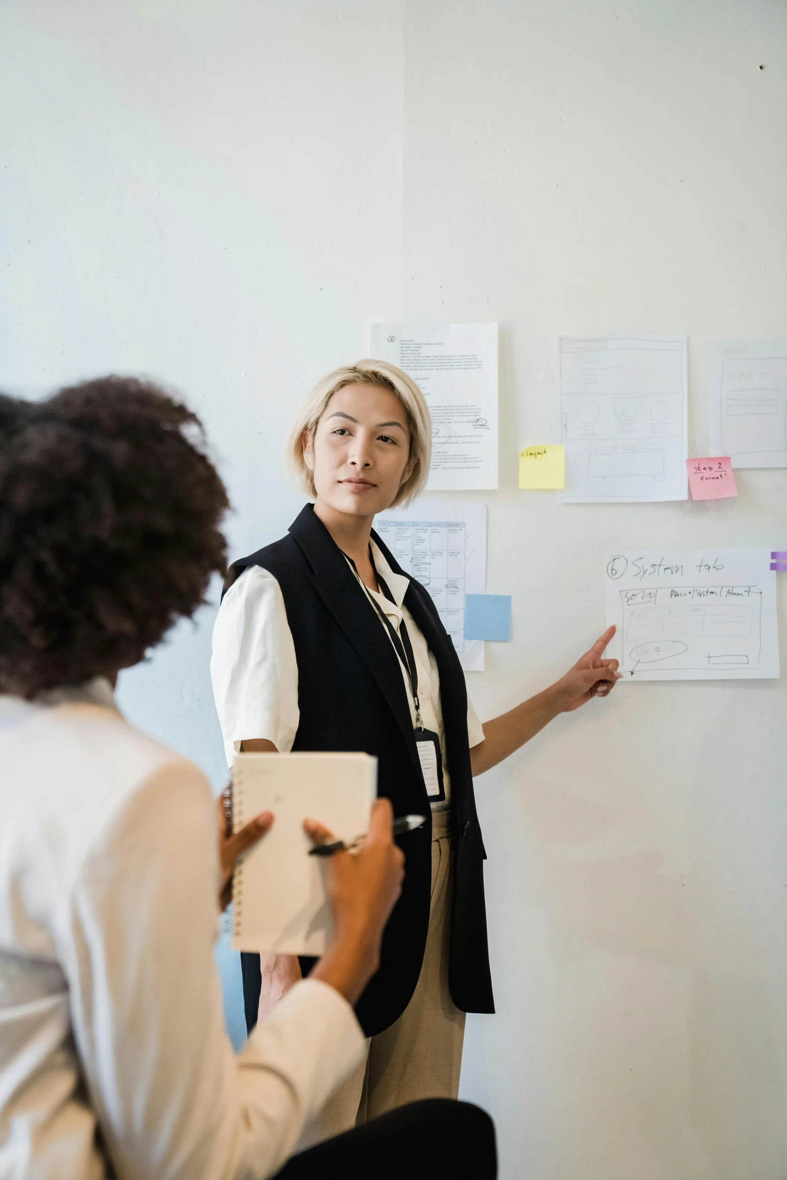 two women working at a board in an office