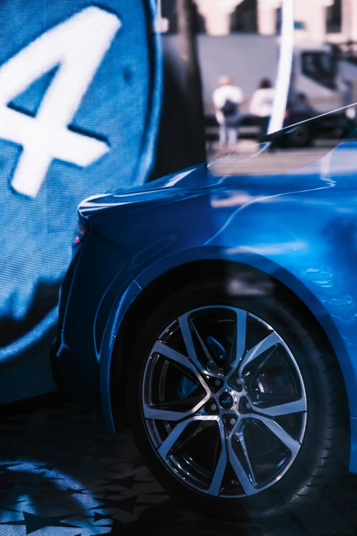 a blue sports car is on display in an advertit