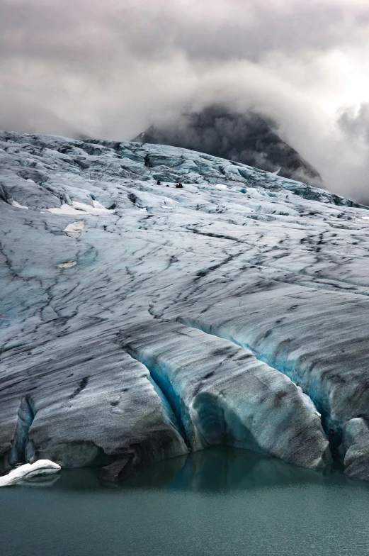 an iceberg partially frozen on the edge of a body of water