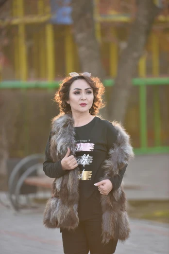 a girl in black pants and a fur coat