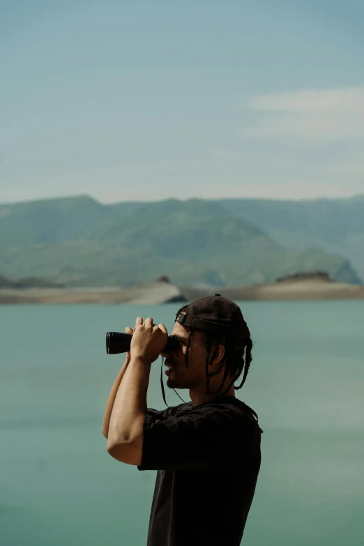 a man taking a po of the ocean from his cellphone