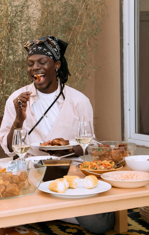 a woman sitting at a table in front of bowls of food