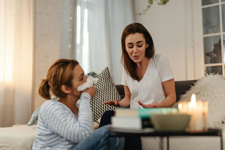 a woman has her teeth brushed off by another woman