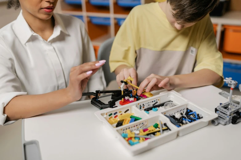 two children in a science class learning robotics