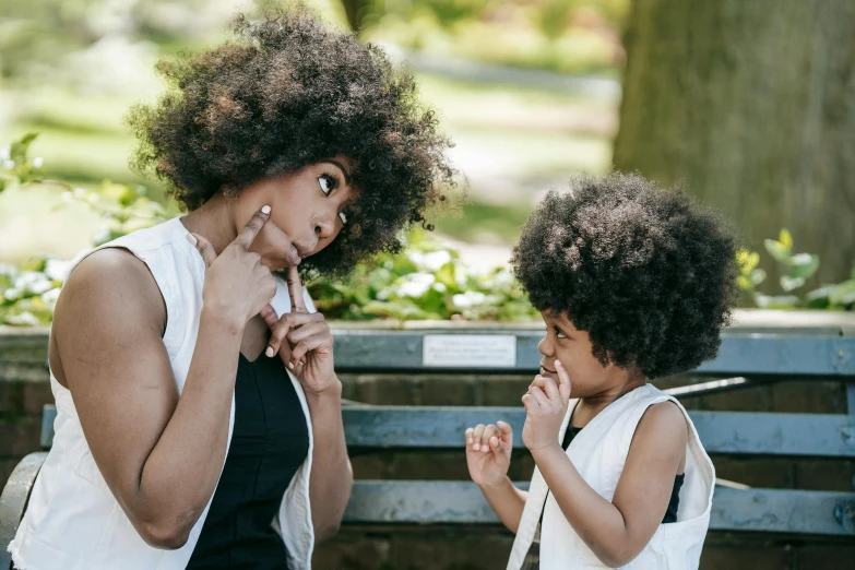 a child holds up an adult's nose to help her smoker