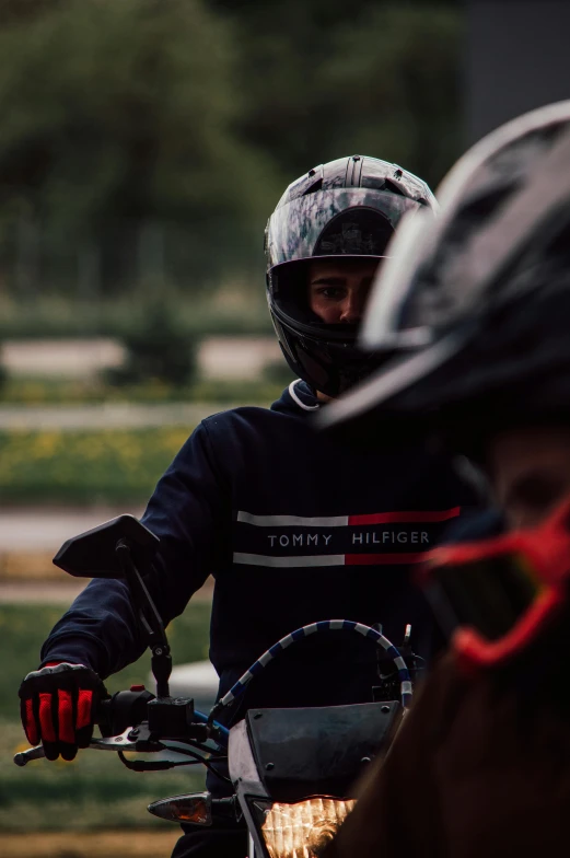 a man riding a motorcycle down the street in helmet