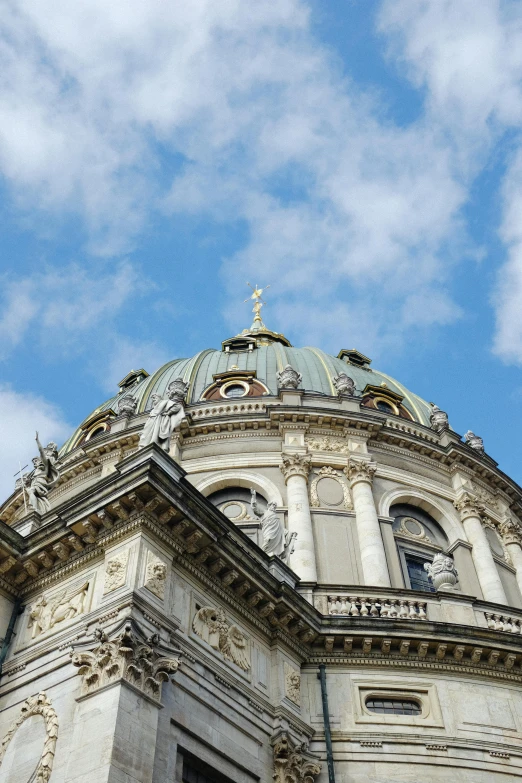 a tall building has a blue dome under it