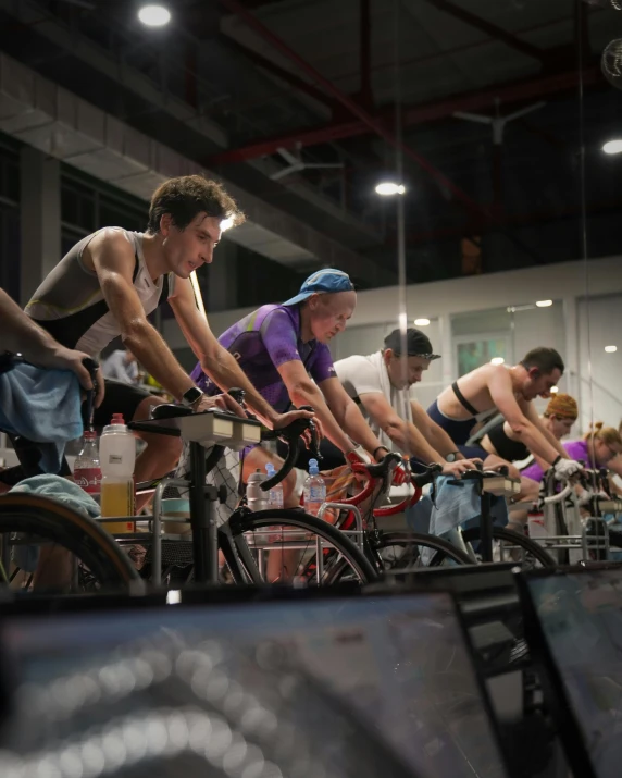 several men and women riding bicycles with helmets on